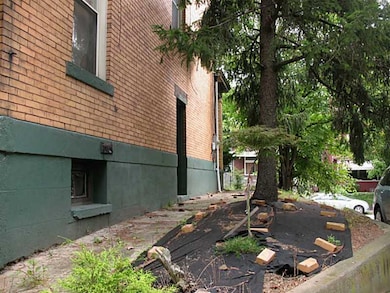 Exterior Back. Driveway is concrete and stone with