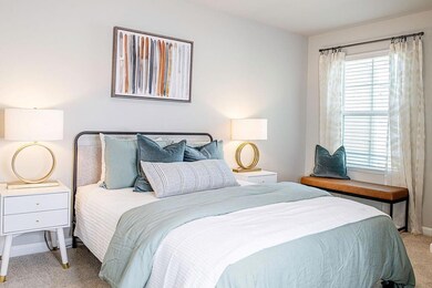 Carpeted bedroom with baseboards
