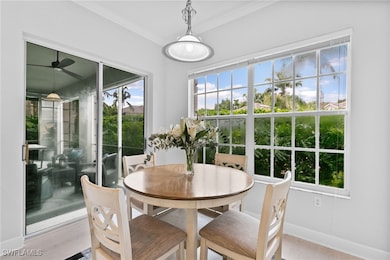 Dining space with ornamental molding and light har