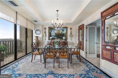 Tiled dining area featuring a raised ceiling, visi