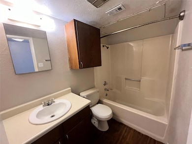 This bathroom has a shower/tub combination. Notice