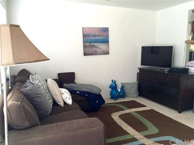 The living room looks into the kitchen & dinin