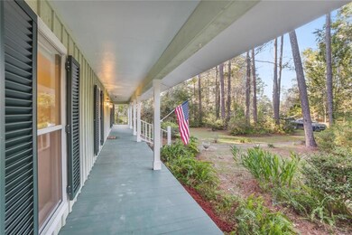 Large front porch with storm shutters across all f