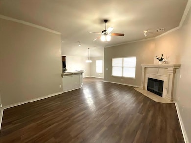 Unfurnished living room featuring dark hardwood / 