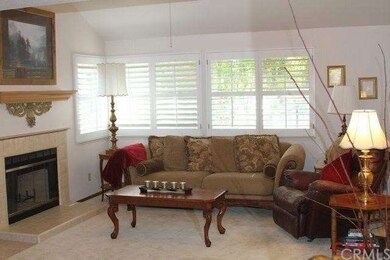 The living room features vaulted ceilings and plan