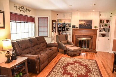 Formal living room with wood flooring and a firepl