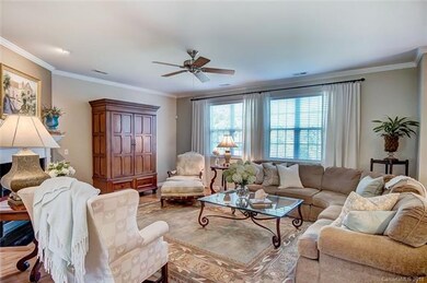 Great Room with Crown Molding and Ceiling Fan