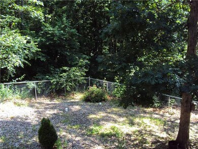 Exterior Back/Side. Backyard chain link fence