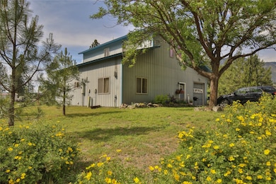 View of property exterior featuring a yard and a garage