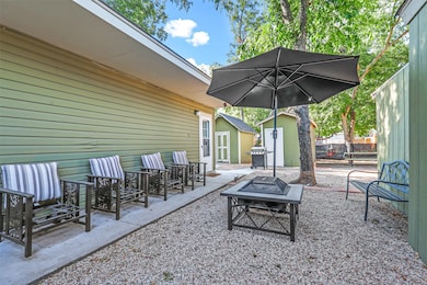 View of patio / terrace with a fire pit and a storage unit