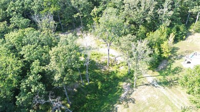 View of property location featuring a heavily wooded area