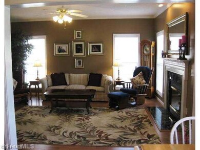 Living Room. Living room has gas log fireplace with marble surround. Door to the back deck is beside of the fireplace.