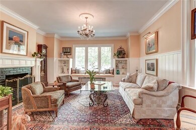 Living room with gas fireplace and beautiful paneling.