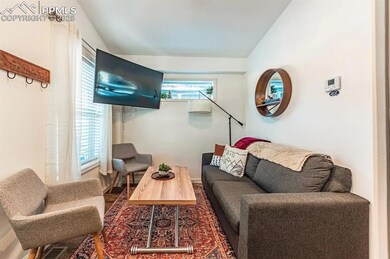Living area featuring lofted ceiling and visible v