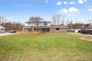 Traditional-style house with brick siding, a porch, and roof with shingles