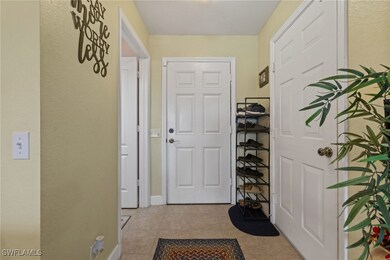 Entryway with light tile patterned floors