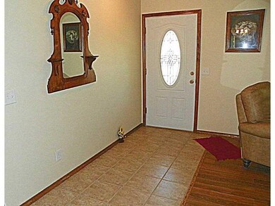 Interior Space/Layout. A lovely leaded glass door & tiled Foyer make a nice separation between LRm  and entry.