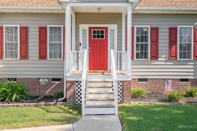 Doorway to property featuring covered porch