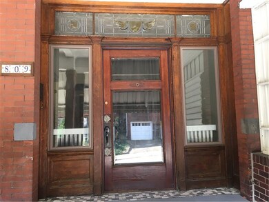 Beautiful wood door with sidelights welcomes plent