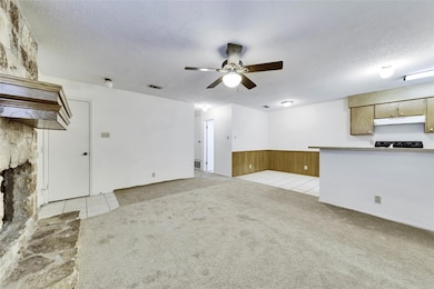 Unfurnished living room featuring a ceiling fan, 