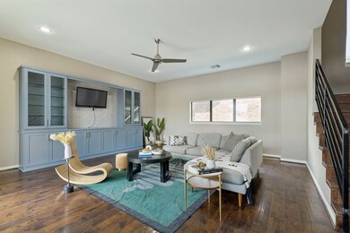 Living room featuring recessed lighting, dark wood-type flooring, stairway, and ceiling fan