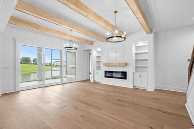 Unfurnished living room featuring beamed ceiling, 