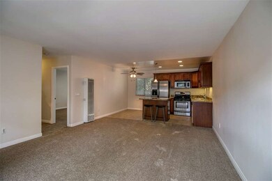 Open-concept living room/kitchen/dining space