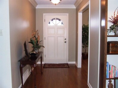 Formal Entry features hardwood floor, custom crown