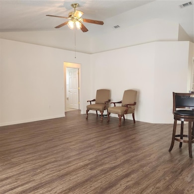 Family room with vaulted ceilings and fresh paint.