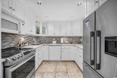 Kitchen with white cabinetry, stainless steel appl