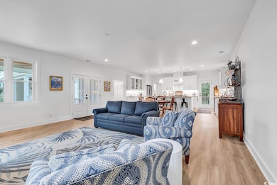 Living room with french doors and light wood-type 