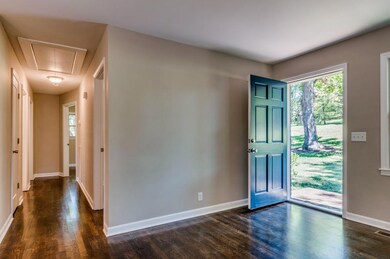 A lovely view out the front door and down the hallway to the 3 bedrooms and hall bath.
