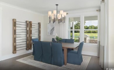 Dining space with a chandelier, dark wood finished floors, and ornamental molding