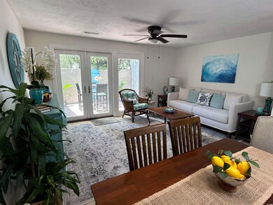 Living room with french doors, ceiling fan, and a 