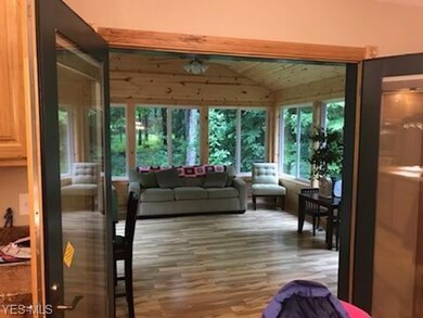 The dining area opens to the knotty pine sunroom t