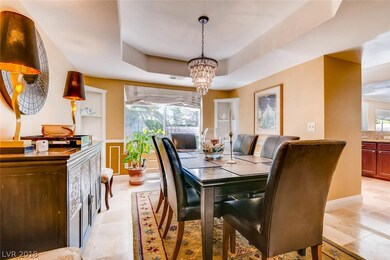 Formal dining room with luxurious lighting and tra