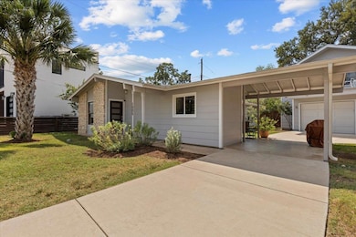 There are multiple parking options, including a detached garage, an attached carport, and plenty of driveway space behind a secure gate.