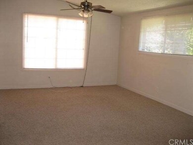 Living room with big window with view of back pati
