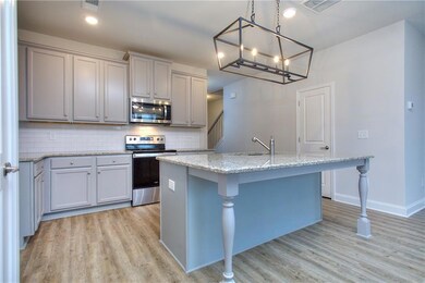 Kitchen featuring a kitchen breakfast bar, light h