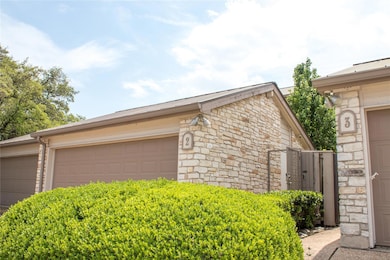View of side of home featuring stone siding and a