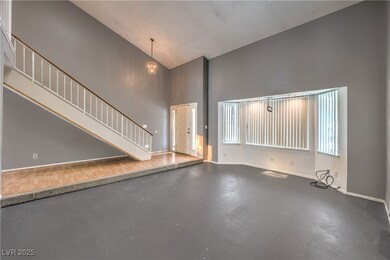 Living room featuring concrete flooring, high vaul