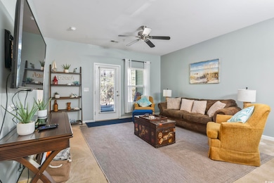 Living area with visible vents, carpet, baseboards