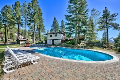 Community pool, hot tub, and lake view clubhouse.
