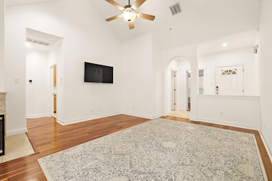 Unfurnished living room with arched walkways, cei
