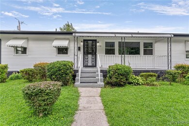 View of front of house with a porch and a front la
