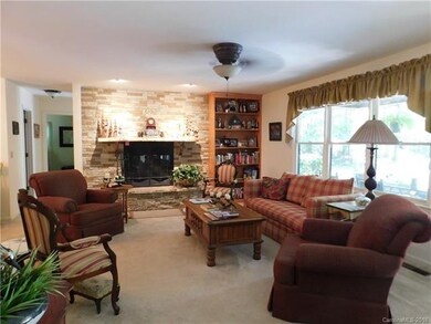 Living room with wood burning fireplace & built in