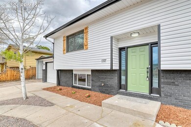 View of exterior entry featuring driveway, fence, 