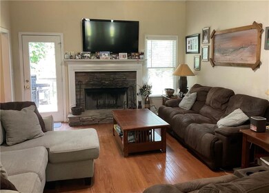 Living area featuring a fireplace and wood finished floors