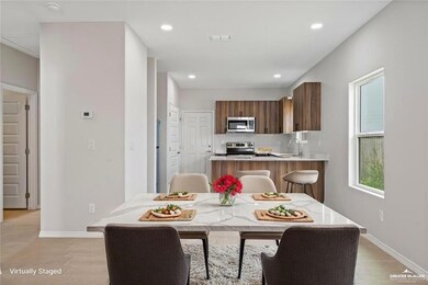 Dining area featuring light wood-style floors, baseboards, and recessed lighting