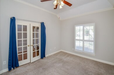 The glass-paned, French doors take you into the st